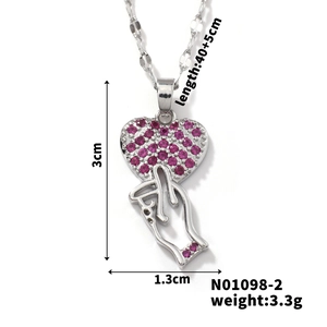 Detail view of silver heart gesture necklace with pink zircon and dimensions specifications