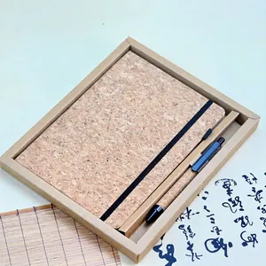 Eco-friendly cork notebook and pen gift set in a minimalist brown kraft paper packaging box