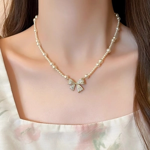 Elegant pearl choker necklace featuring a sparkling zircon bow pendant for women