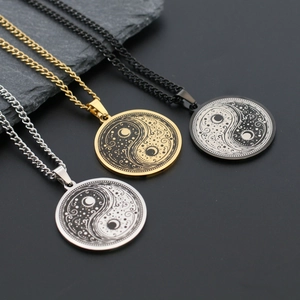 Three men's stainless steel Yin Yang necklaces in silver, gold, and black finishes