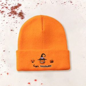 Detail shot of pumpkin embroidery and Happy Halloween text on orange knit beanie