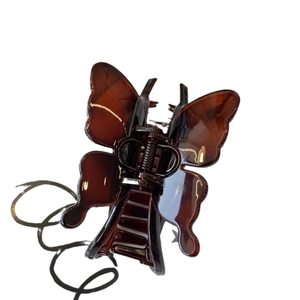 Large butterfly hair claw clip in amber brown resin for elegant women styling