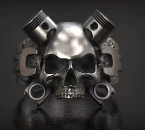 Detailed view of mechanical skull ring featuring dual pistons and wrench engraving