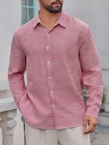Close-up of red and white striped cotton fabric texture on a long sleeve shirt