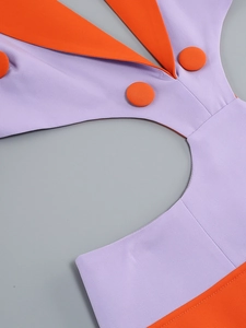 Detailed close-up of V-neck cutout dress with purple and orange stitching and buttons