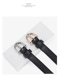 Detail of lychee pattern leather belts featuring round gold and silver metal buckles