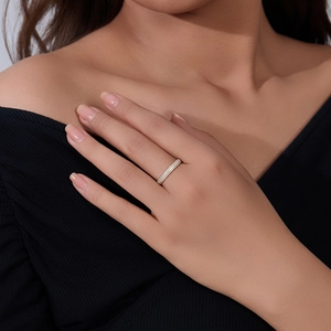 Detail of a slender gold eternity ring with double-row micro-pave cubic zirconia stones