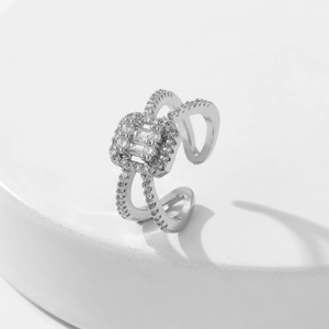 Macro shot of silver open ring featuring a square zircon center and pavé stripes