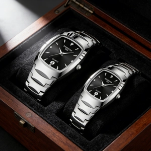 Macro shot of silver quartz watches for couples in a dark wood display gift box