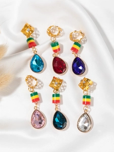 Detail view of colorful crystal teardrop pendants for African hair braid decoration