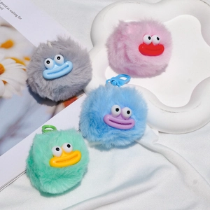 Close-up of colorful furry monster keychains with funny expressions and plastic buckles