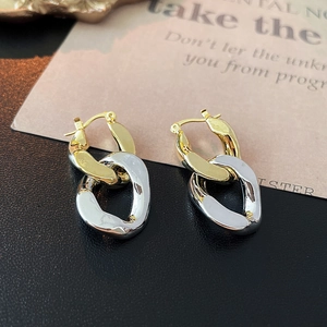 Two-tone gold and silver chain link hoop earrings with a modern geometric design