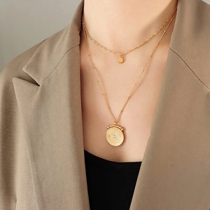 French vintage double-layered titanium steel necklace with sun and coin pendants on a model