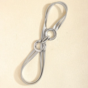 Detail of silver elastic waist belt with double ring buckle and snake chain texture finish
