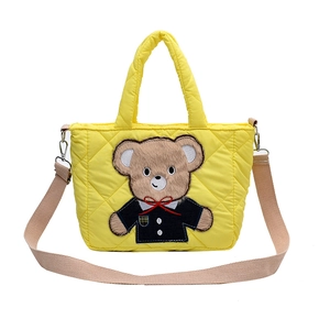 Yellow quilted shoulder bag with cute cartoon bear patch for kids and fashion-forward adults