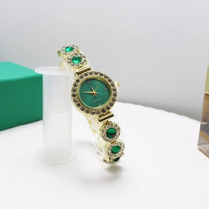 Elegant gold quartz watch with green dial and gemstone bracelet for women