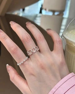 Close-up of minimalist S925 sterling silver beaded and geometric hollow open rings