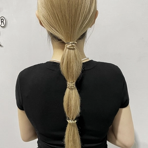 Three-piece golden metallic ponytail clips featuring minimalist wavy and woven geometric designs
