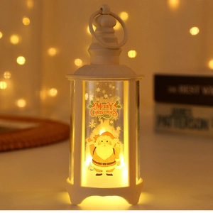 Detail of white Christmas LED lantern with Santa Claus motif and warm glowing light