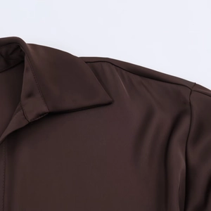 Detail view of smooth dark brown satin blouse collar with premium stitching quality