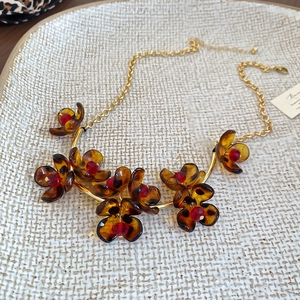 Detailed macro view of retro amber floral pendant necklace with leopard print tortoise texture