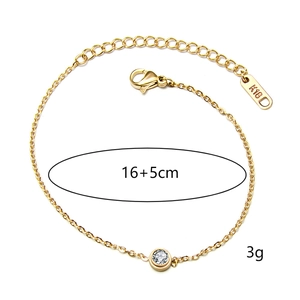 Macro detail of gold-plated titanium bracelet with K18 tag and sparkling round zircon