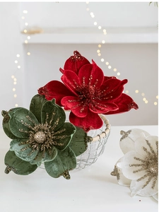 Close-up of velvet artificial magnolia flowers with glitter petals in red, green and white