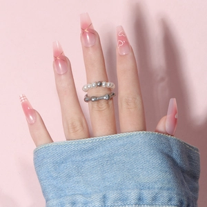 Pink gradient coffin press-on nails with white heart patterns and gold line accents