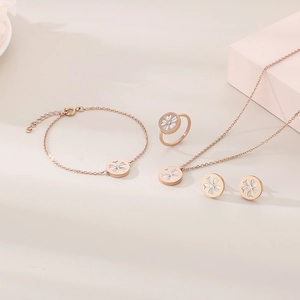 Rose gold flower jewelry set with white shell petals and central diamond detail