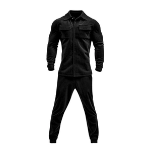 Detail of black faux suede shirt jacket and pants showing soft matte fabric texture