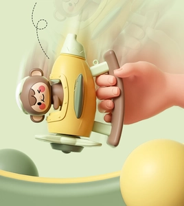 Detail view of yellow toy airplane with cute monkey pilot and ergonomic brown handle