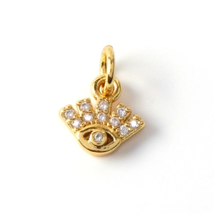 Macro shot of 18k gold plated evil eye pendant with sparkling white cubic zirconia stones
