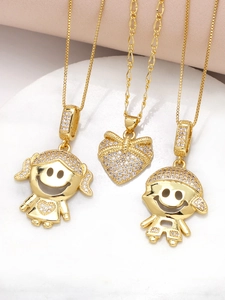 Close-up of gold-plated heart and boy-girl pendant necklaces with cubic zirconia stones