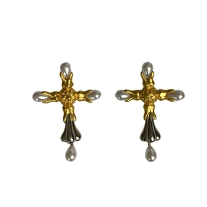 Baroque style cross earrings with gold-silver tones and faux pearls on white background