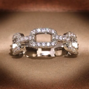 Detail view of silver chain ring with white cubic zirconia set in a jewelry box