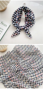 Close-up of checkerboard cotton linen scarf with colorful pixel art patterns and soft texture