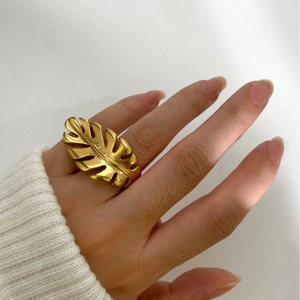 Elegant 18k gold plated stainless steel leaf ring displayed on a hand with white background