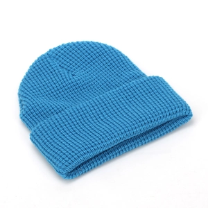 Classic bright blue cuffed beanie hat with thick knit texture for winter warmth