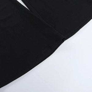 Close-up of double-stitched hem and textured knit fabric on black lace jumpsuit