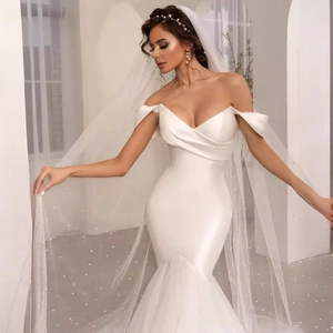 Elegant white satin off-shoulder mermaid wedding dress with sheer tulle skirt and long veil