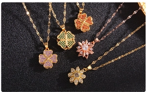 Detailed macro view of zircon-inlaid rotating clover and flower pendants on black texture