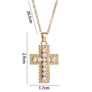 Detailed view of the gold cross pendant with dimensions of 2.9cm by 1.7cm and zircon pearls