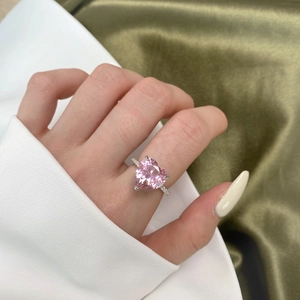 Close-up of luxury S925 silver ring featuring a large pink heart-cut carbon diamond