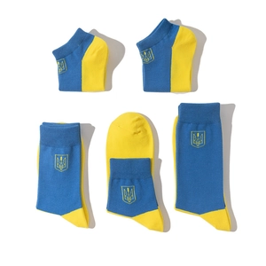 Close-up of blue and yellow cotton socks set featuring embroidered trident emblem symbols