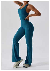 Macro side view of quick-dry peacock blue flared yoga jumpsuit with racerback design
