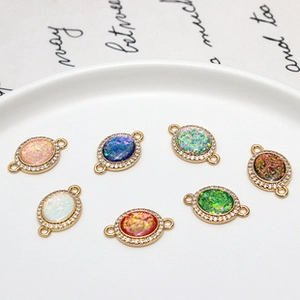Macro detail of oval copper zircon connectors with colorful faux opal insets for DIY jewelry