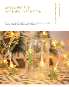 Detail of warm white LED Christmas tree lights wrapped on glass jar for festive decor