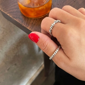 Detail of S925 sterling silver twisted rope and spiral vintage rings on hand