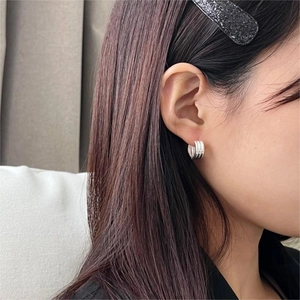 Minimalist 925 sterling silver multi-layered hoop earrings shown on a female model