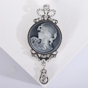 Vintage silver brooch with rhinestone cameo portrait and elegant teardrop pendant